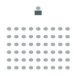 Rows of chairs with one table and chair at the front